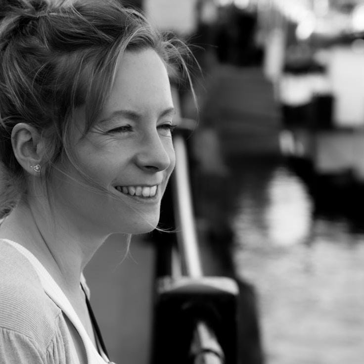 Nova Reed, Lead Design Curator at Primrose & Co., reviewing corporate floral arrangements